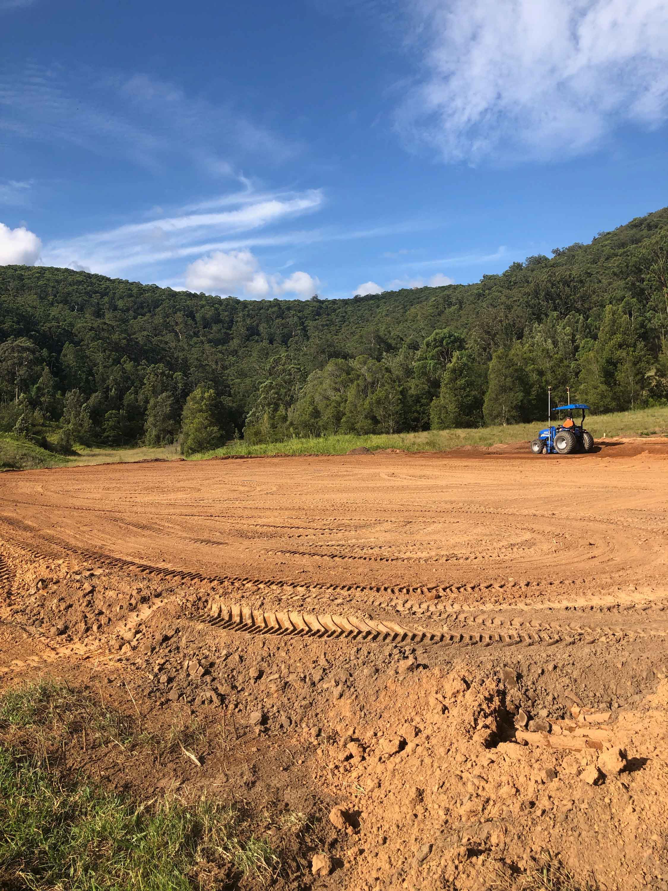 Tractor leveling out site for large acreage home