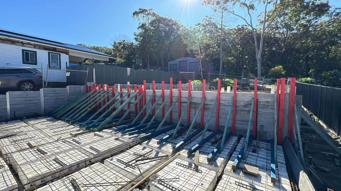 Sloping site split slab design Deep beams 